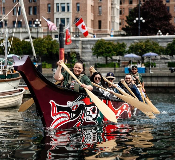 A canoe tour with Songhees Tours paddles across the Inner Harbour in Victoria, BC