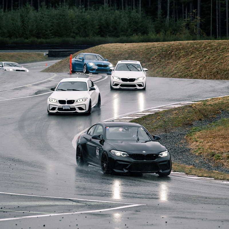 Five BMWs negotiate the corners of the Vancouver Island Motorsport Circuit