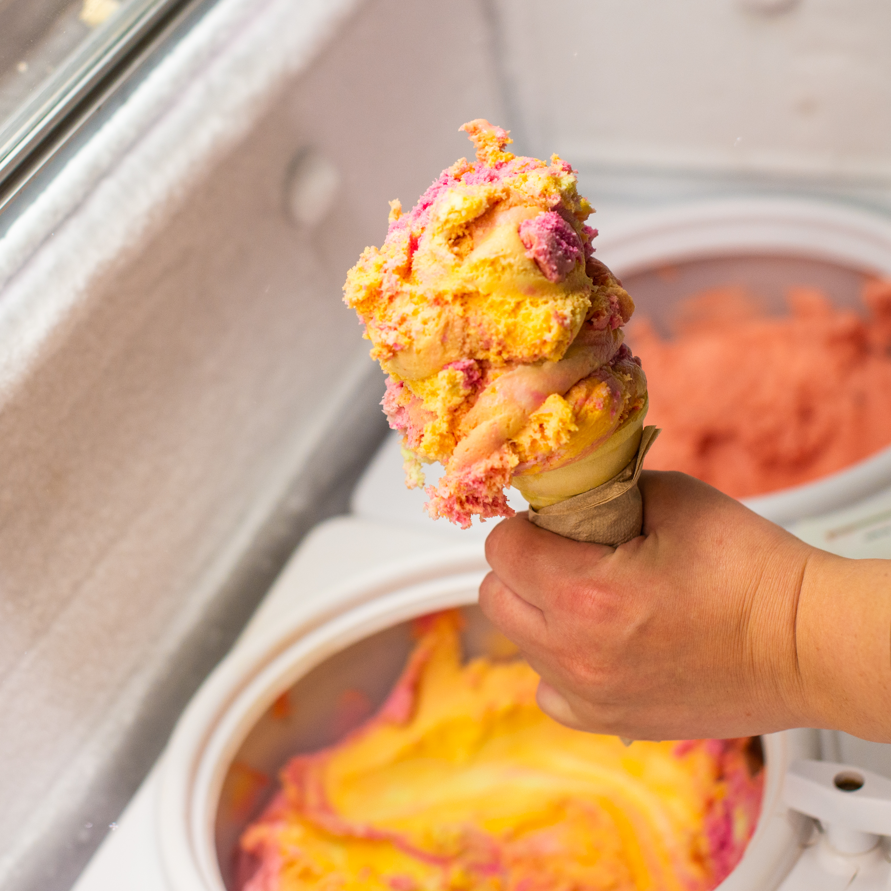 A scoop of orange and pink ice cream served at Red Barn Market