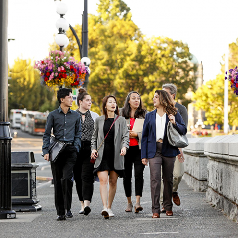 Professionals walk along Victoria's Government Street